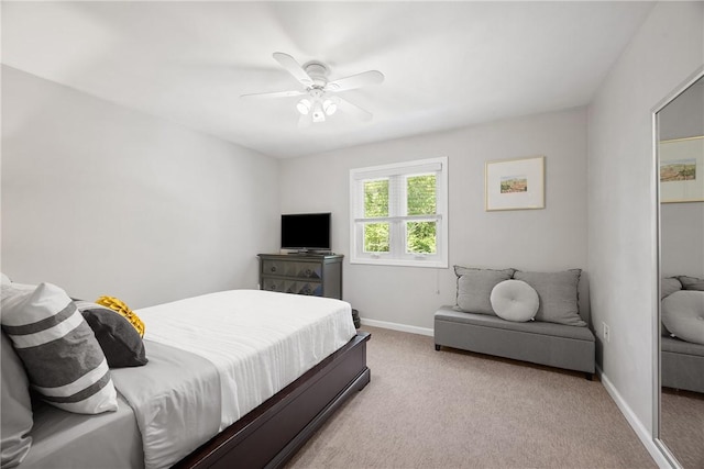 carpeted bedroom featuring baseboards and a ceiling fan