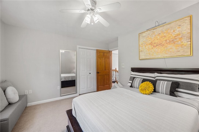 bedroom with carpet flooring, baseboards, ceiling fan, and a closet