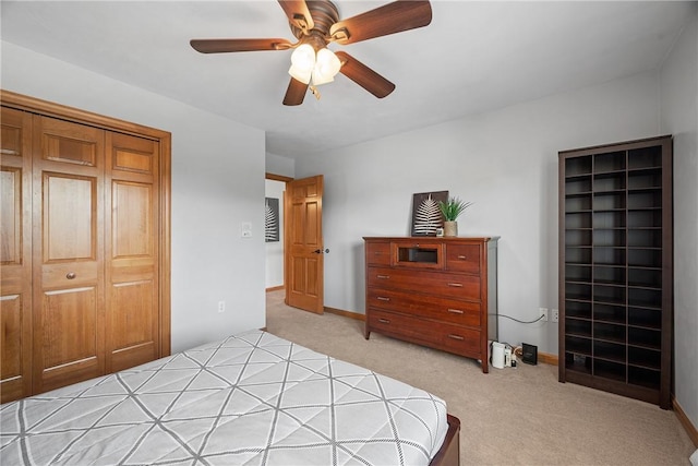 bedroom featuring light carpet, ceiling fan, and baseboards