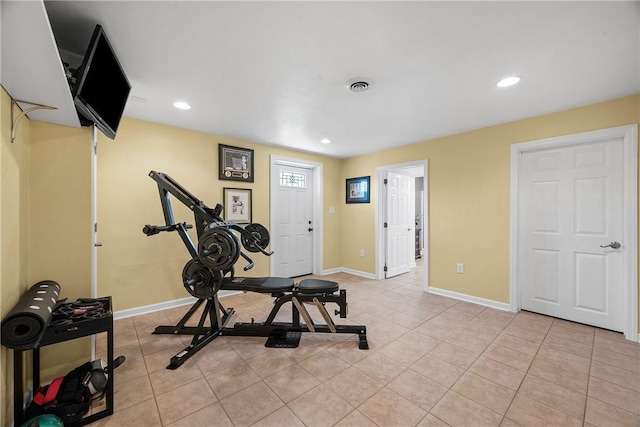 exercise room with baseboards, light tile patterned floors, and recessed lighting