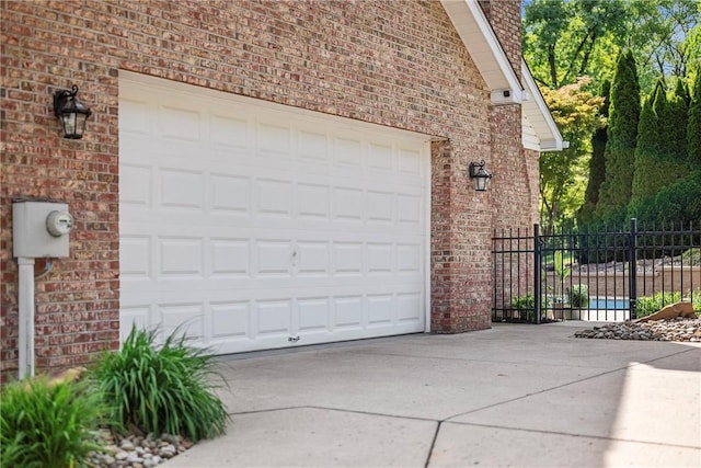 garage with driveway and fence