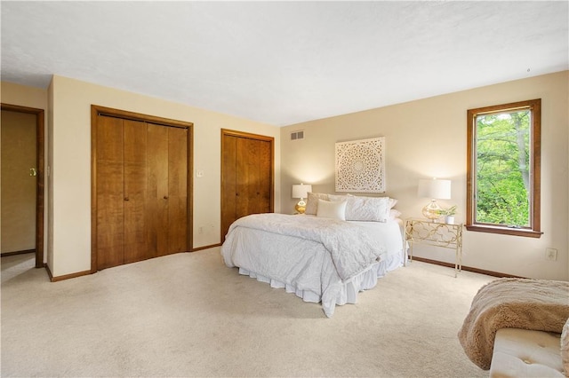 114 Moore Dr, Peters Twp, PA 15317 - bedroom featuring two closets, baseboards, and light colored carpet