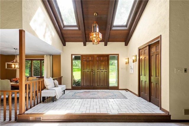 114 Moore Dr, Peters Twp, PA 15317 - foyer entrance with a skylight, a chandelier, wood ceiling with exposed beams, a textured wall, and baseboards