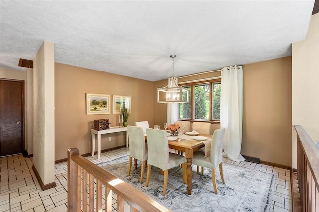 114 Moore Dr, Peters Twp, PA 15317 - dining room featuring baseboards and a chandelier