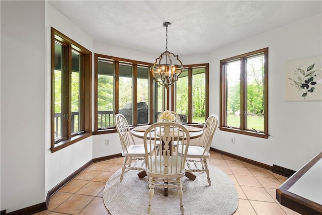 114 Moore Dr, Peters Twp, PA 15317 - dining area featuring healthy amount of natural light, light tile patterned flooring, a chandelier, and baseboards