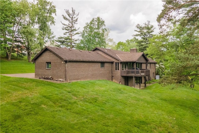 114 Moore Dr, Peters Twp, PA 15317 - back of house featuring a lawn, a chimney, brick siding, a deck, and a sunroom
