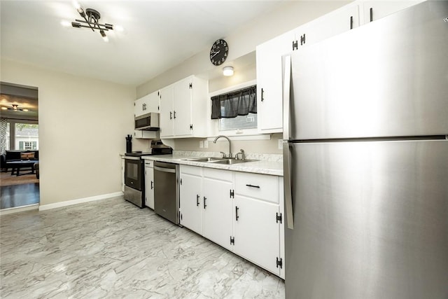234 E Neshannock Ave, New Wilmington Boro, PA 16142 - kitchen with appliances with stainless steel finishes, a sink, light marble finish flooring, light countertops, and white cabinetry