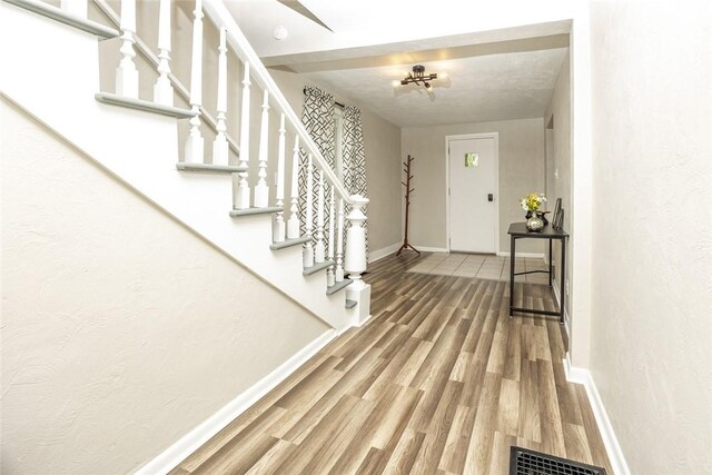 234 E Neshannock Ave, New Wilmington Boro, PA 16142 - entrance foyer with baseboards, wood finished floors, and stairway
