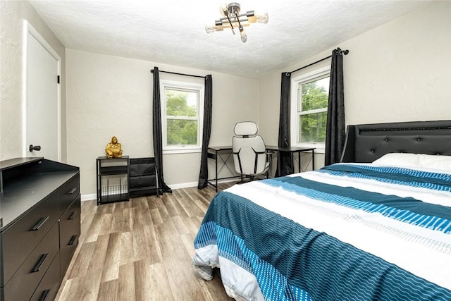 234 E Neshannock Ave, New Wilmington Boro, PA 16142 - bedroom featuring light wood-style flooring, a textured ceiling, and baseboards