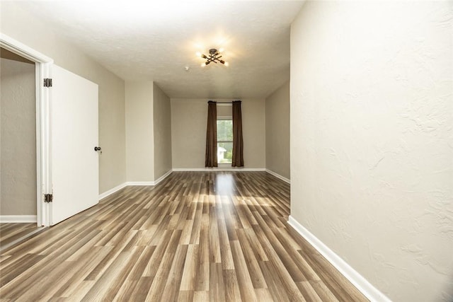 234 E Neshannock Ave, New Wilmington Boro, PA 16142 - spare room with wood finished floors, baseboards, and a textured wall