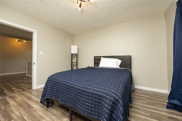 234 E Neshannock Ave, New Wilmington Boro, PA 16142 - bedroom featuring a textured ceiling, wood finished floors, and baseboards