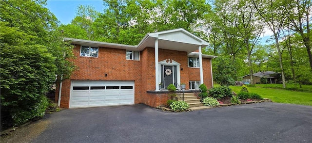 532 Strope Rd, Pa, PA 15021 - bi-level home with driveway, an attached garage, and brick siding