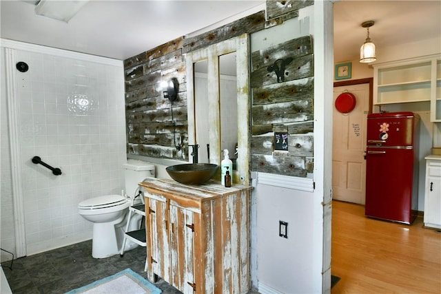 375 Main St, Volant Boro, PA 16156 - bathroom featuring tile walls, toilet, vanity, and wood finished floors