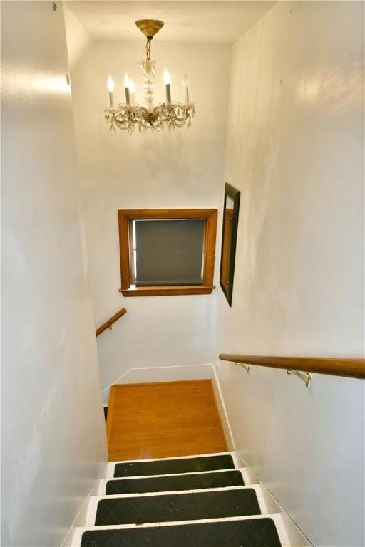 375 Main St, Volant Boro, PA 16156 - stairs with a chandelier, baseboards, and vaulted ceiling