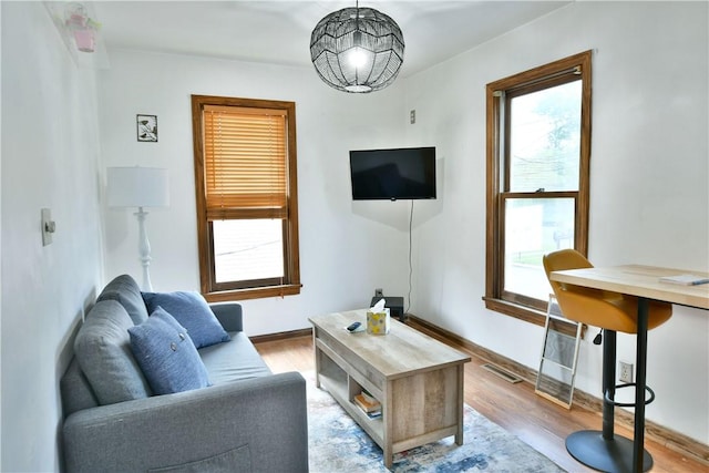 375 Main St, Volant Boro, PA 16156 - living room with light wood finished floors, a chandelier, and baseboards