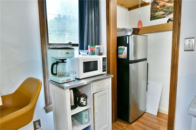 375 Main St, Volant Boro, PA 16156 - kitchen with freestanding refrigerator, white microwave, light wood finished floors, white cabinetry, and open shelves