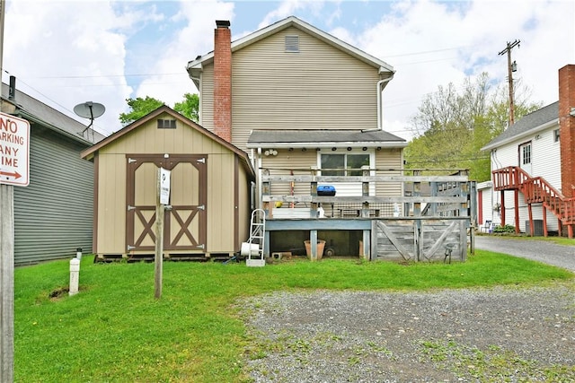 375 Main St, Volant Boro, PA 16156 - rear view of house with a storage unit, an outdoor structure, a yard, a deck, and a chimney