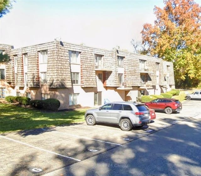 view of property featuring uncovered parking