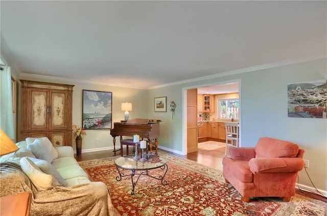 living area with light wood-style floors, crown molding, and baseboards