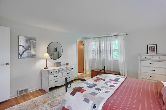 bedroom with light wood-style flooring and baseboards