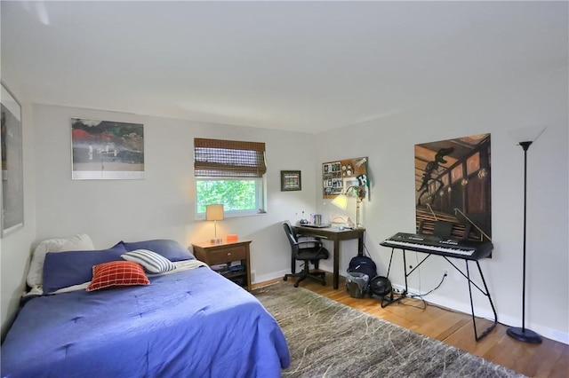 bedroom featuring wood finished floors and baseboards