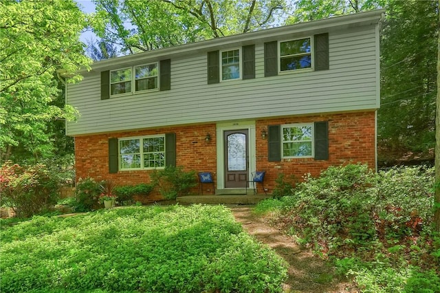 colonial-style house featuring brick siding