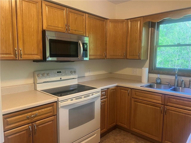 150 Long Hill Rd, Salem Twp Mer, PA 16130 - kitchen featuring stainless steel microwave, white electric range, a sink, brown cabinetry, and light countertops