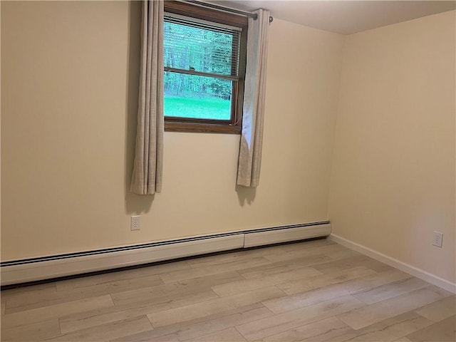 150 Long Hill Rd, Salem Twp Mer, PA 16130 - spare room with a baseboard heating unit, light wood finished floors, and baseboards