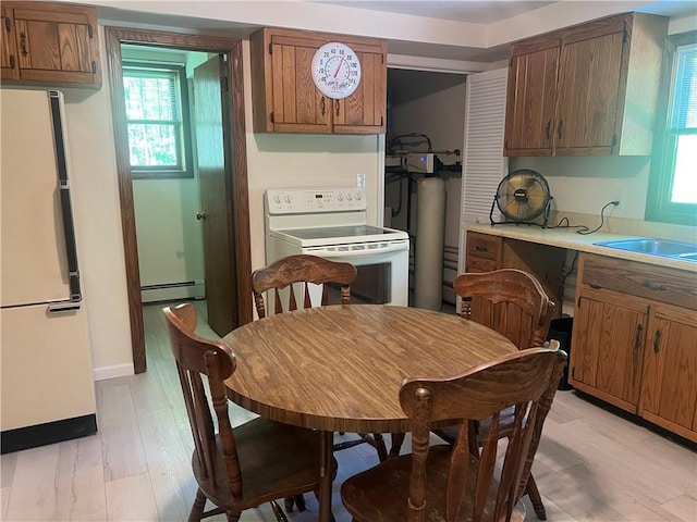 150 Long Hill Rd, Salem Twp Mer, PA 16130 - kitchen featuring white appliances, a baseboard heating unit, healthy amount of natural light, and light countertops