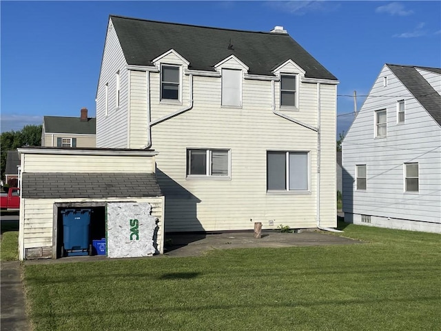 rear view of house featuring a yard