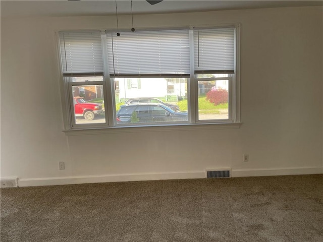 empty room with carpet flooring and baseboards