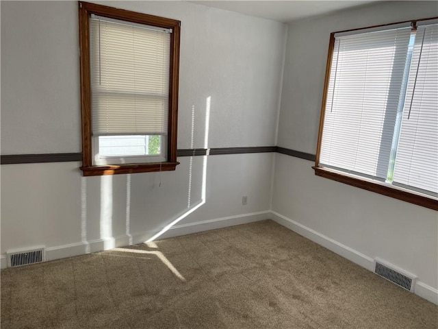 unfurnished room featuring carpet flooring and baseboards