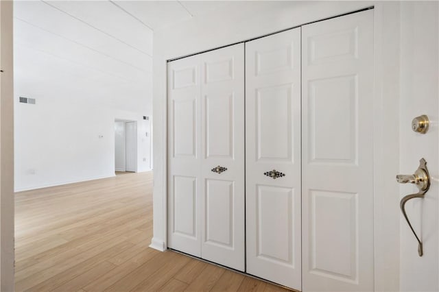 corridor featuring light wood finished floors