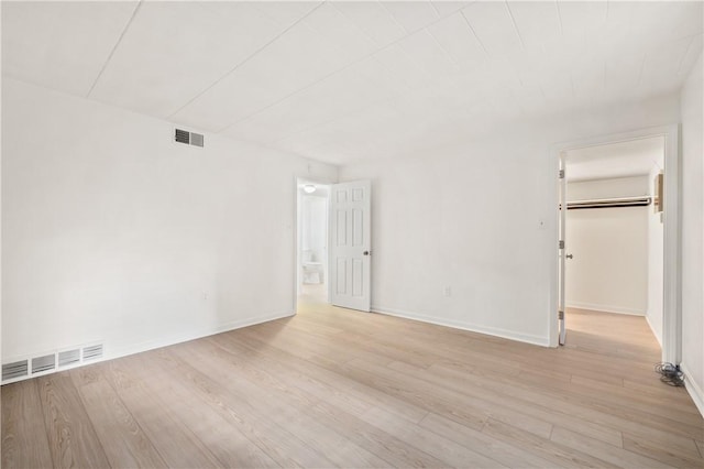 unfurnished room with wood finished floors and baseboards