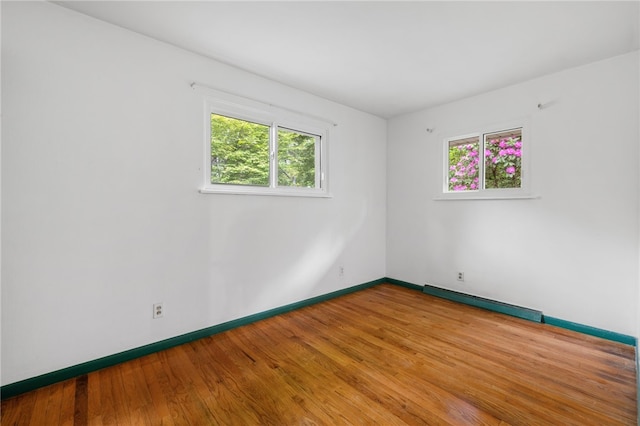 318 Milbren Dr, Penn Hills, PA 15147 - spare room featuring a baseboard radiator, baseboards, and wood finished floors