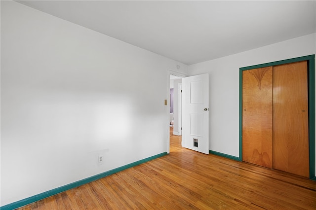 318 Milbren Dr, Penn Hills, PA 15147 - unfurnished bedroom with wood finished floors, baseboards, and a closet