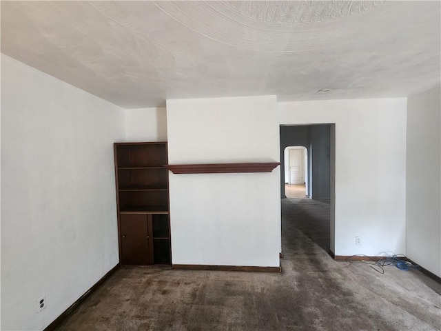 421 32nd St, Mckeesport, PA 15132 - carpeted empty room featuring baseboards and arched walkways