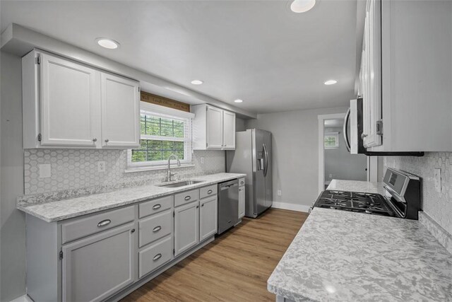 13 Chestnut St, South Fayette, PA 15082 - kitchen featuring a sink, appliances with stainless steel finishes, light countertops, decorative backsplash, and recessed lighting