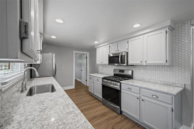 13 Chestnut St, South Fayette, PA 15082 - kitchen featuring appliances with stainless steel finishes, a sink, backsplash, dark wood-style floors, and recessed lighting