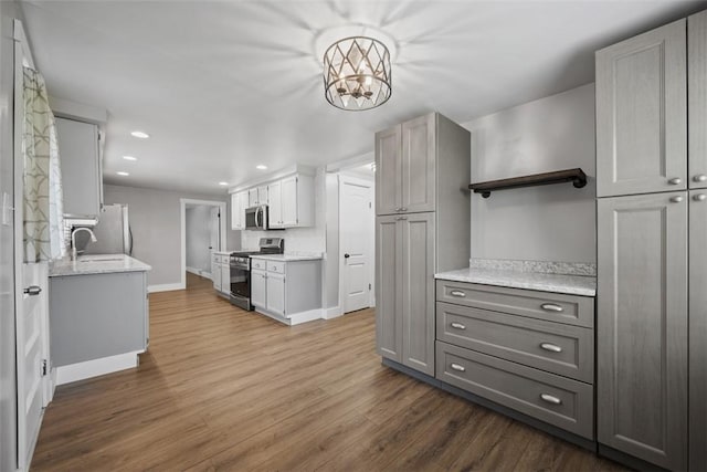 13 Chestnut St, South Fayette, PA 15082 - kitchen with stainless steel appliances, open shelves, gray cabinets, baseboards, and dark wood-style flooring