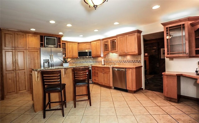 107 Great Oaks Dr, Moon/Crescent Twp, PA 15108 - kitchen featuring appliances with stainless steel finishes, recessed lighting, backsplash, a kitchen breakfast bar, and open shelves