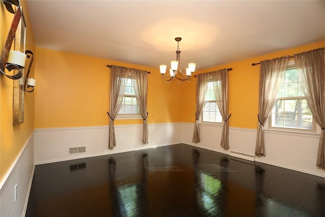107 Great Oaks Dr, Moon/Crescent Twp, PA 15108 - empty room with baseboard heating, healthy amount of natural light, a chandelier, and wood finished floors