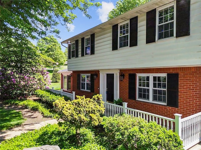 colonial home with brick siding