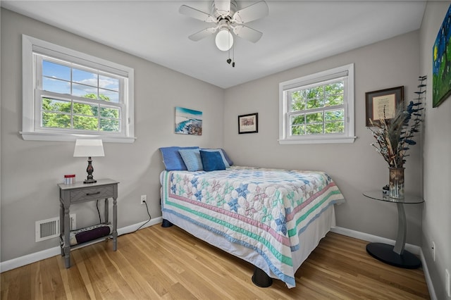 bedroom with baseboards, wood finished floors, and ceiling fan