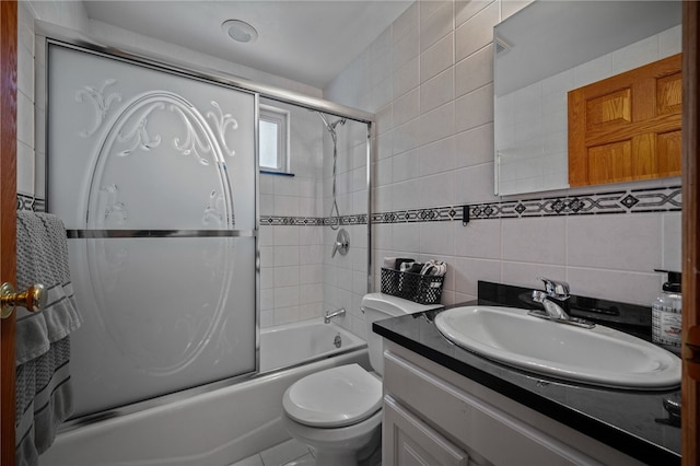 full bath with tile walls, shower / bath combination with glass door, vanity, toilet, and decorative backsplash