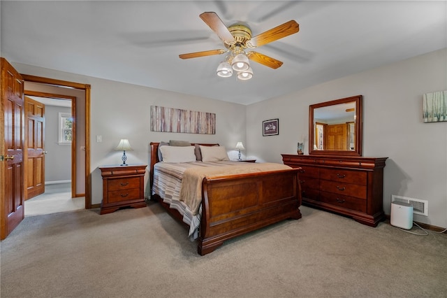 bedroom featuring light colored carpet, baseboards, and ceiling fan