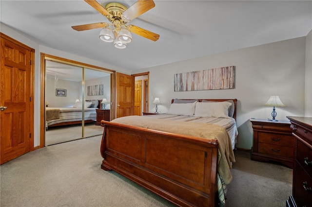 bedroom with light colored carpet, a closet, and a ceiling fan