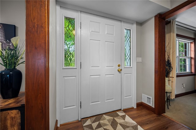 foyer entrance featuring baseboards and dark wood-style floors