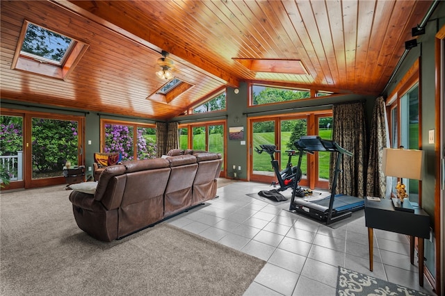 tiled living room featuring a skylight, wooden ceiling, and healthy amount of natural light