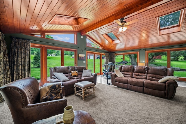 carpeted living room with a skylight, wooden ceiling, and a ceiling fan